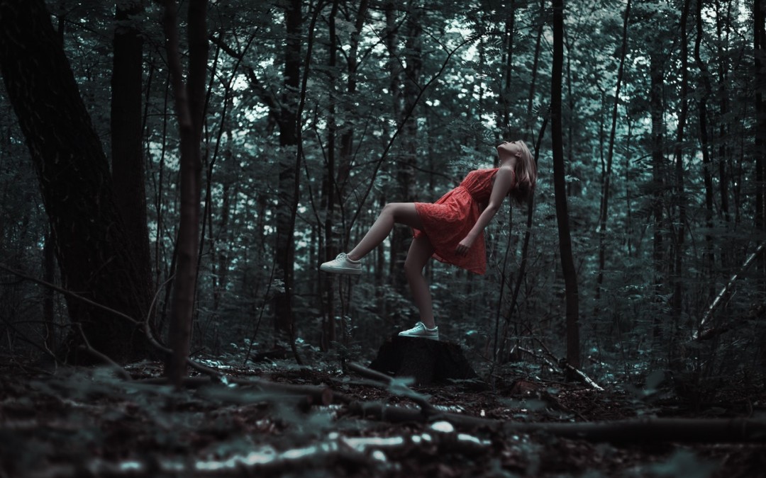 Image of a girl floating in the forest